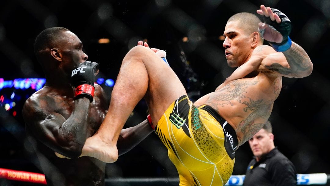 Brazil's Alex Pereira kicks Nigeria's Israel Adesanya during the first round of a middleweight bout at the UFC 281.