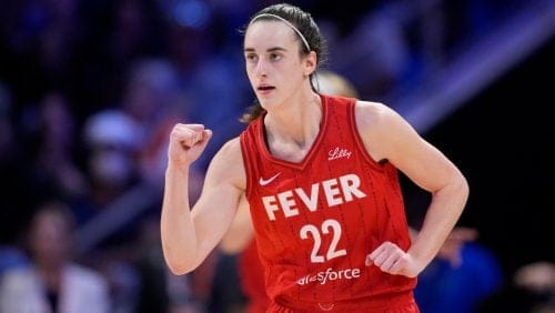 Indiana Fever's Caitlin Clark celebrates in the second half of a WNBA basketball game against the Dallas Wings, Wednesday, July 17, 2024, in Arlington, Texas.