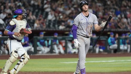 Colorado Rockies' Ryan McMahon, right, flips his bat after striking out as Arizona Diamondbacks catcher Gabriel Moreno, left, hold the ball during the ninth inning of a baseball game Friday, May 16, 2025, in Phoenix.