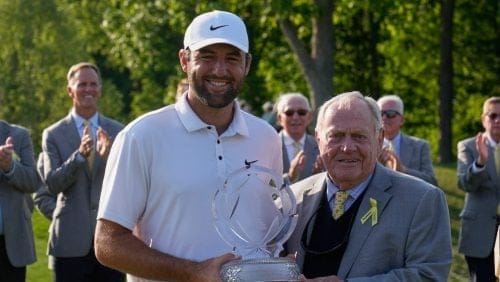 Scottie Scheffler, left, and Jack Nicklaus, right, pose with the trophy after Scheffler won the Memorial golf tournament Sunday, June 1, 2025, in Dublin, Ohio.