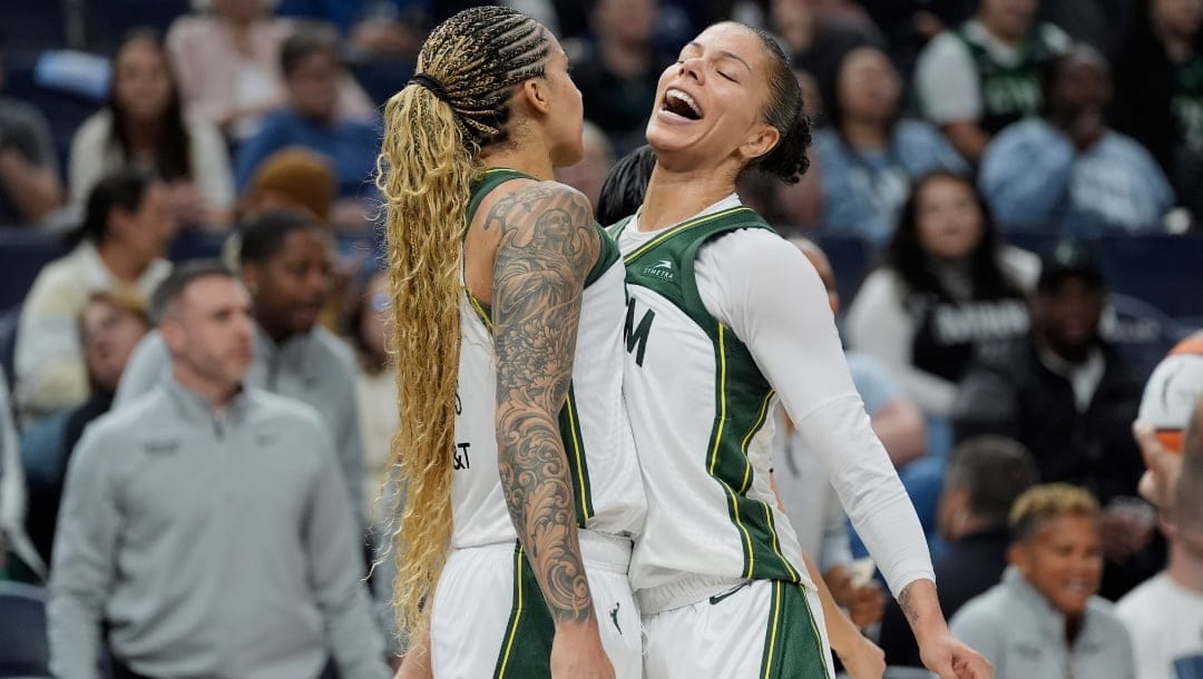 Seattle Storm forwards Gabby Williams (5), left, and Alysha Clark (32) celebrate during the second half of a WNBA basketball game against the Minnesota Lynx, Tuesday, May 27, 2025, in Minneapolis.