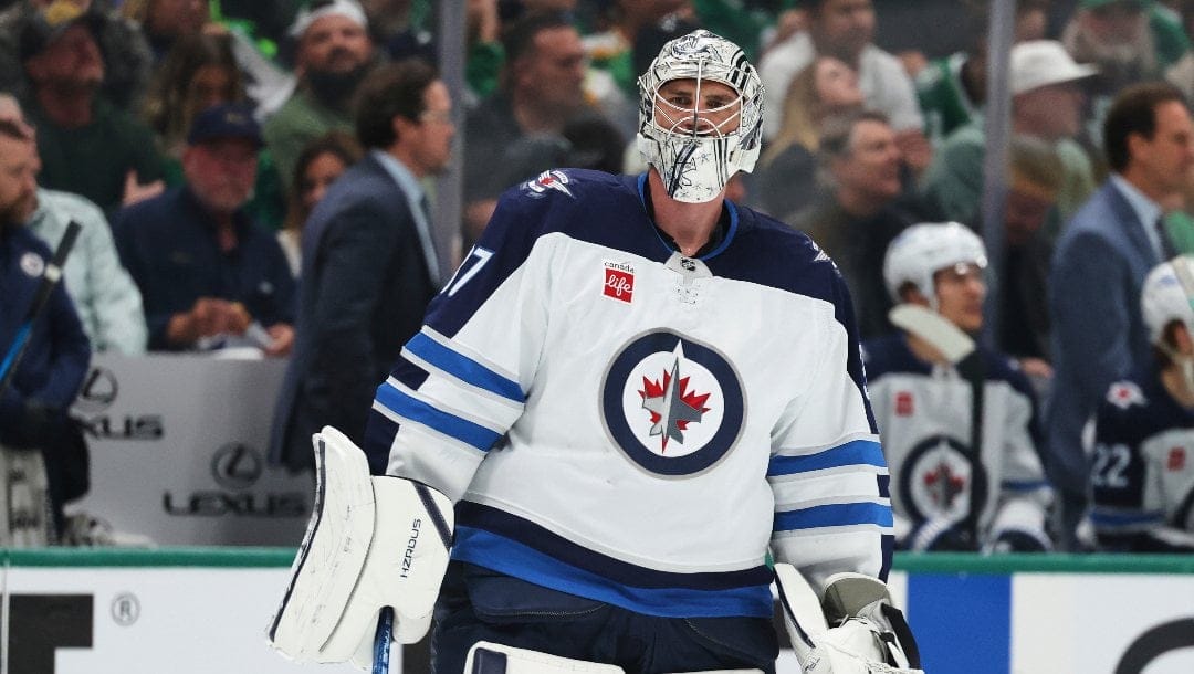 Winnipeg Jets goaltender Connor Hellebuyck skates on the ice during a media time out in the first period of Game 4 of a second-round NHL hockey playoff series aginast the Dallas Stars in Dallas, Tuesday, May 13, 2025.