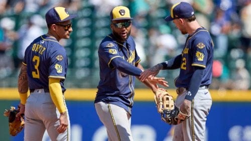 Milwaukee Brewers shortstop Joey Ortiz (3), right fielder Jackson Chourio, center and second baseman Brice Turang celebrate after a baseball game against the Seattle Mariners, Wednesday, July 23, 2025, in Seattle.