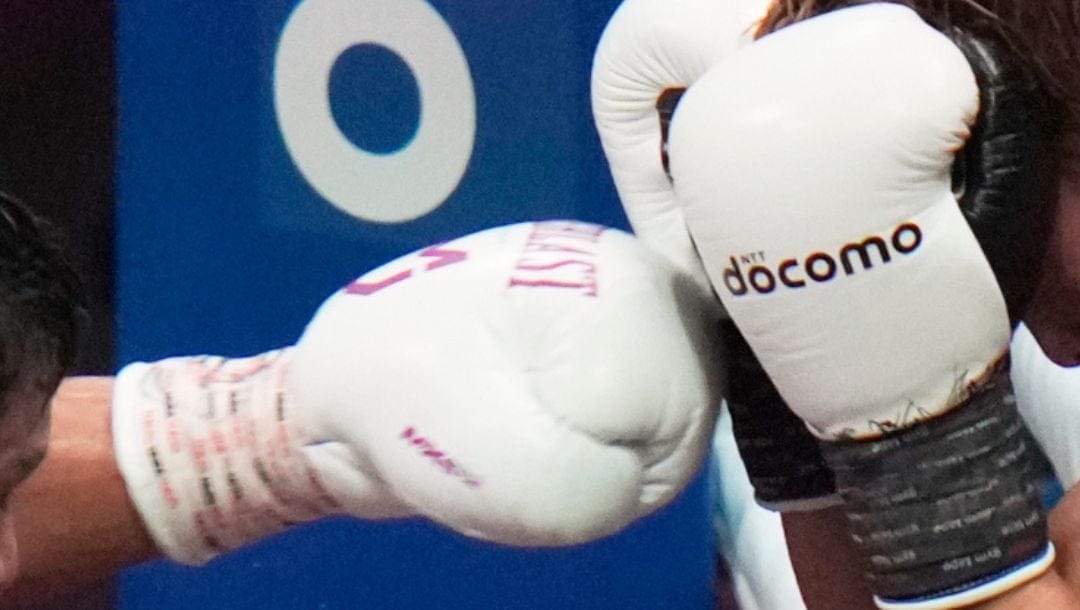 Japanese champion Naoya Inoue, right, faces challenger from Uzbekistan Murodjon Akhmadaliev during a boxing match.