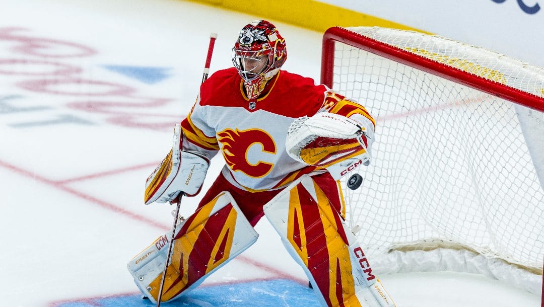 Calgary Flames goaltender Dustin Wolf warms up before an NHL hockey game against the Seattle Kraken, Monday, Sept. 29, 2025, in Seattle.